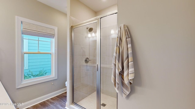 bathroom featuring hardwood / wood-style floors and a shower with shower door