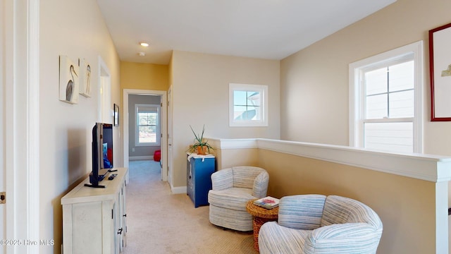 sitting room featuring light colored carpet