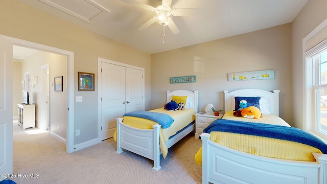 carpeted bedroom with ceiling fan and a closet