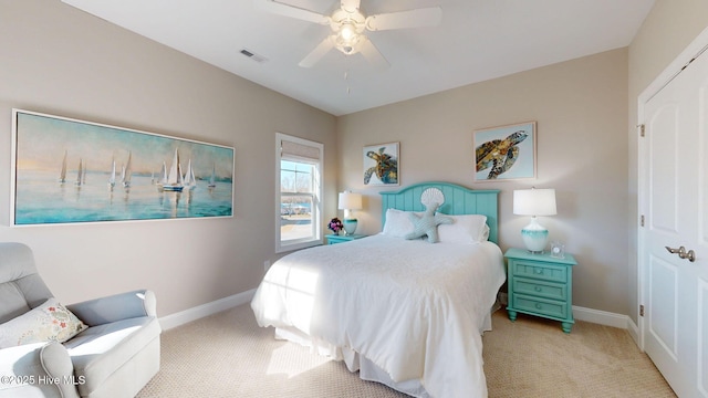 bedroom with ceiling fan and light carpet