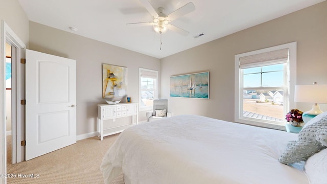 bedroom featuring light colored carpet and ceiling fan