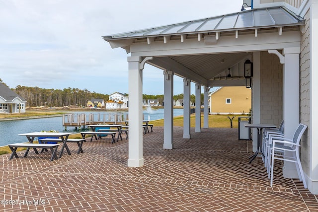 view of patio / terrace featuring a gazebo and a water view