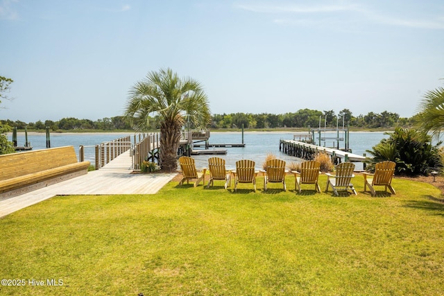 view of yard featuring a dock and a water view