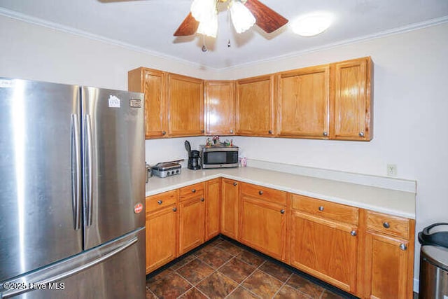 kitchen with ceiling fan, crown molding, and stainless steel appliances