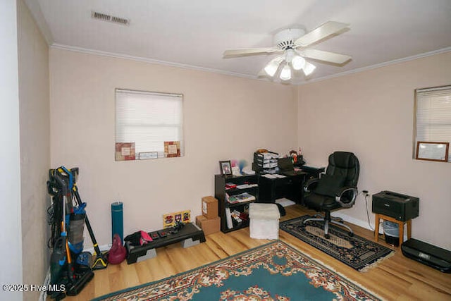 home office with wood-type flooring, ceiling fan, and crown molding