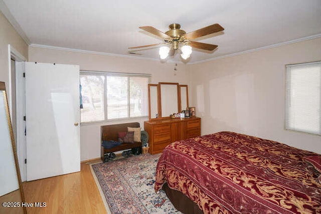 bedroom featuring ceiling fan, crown molding, and light wood-type flooring