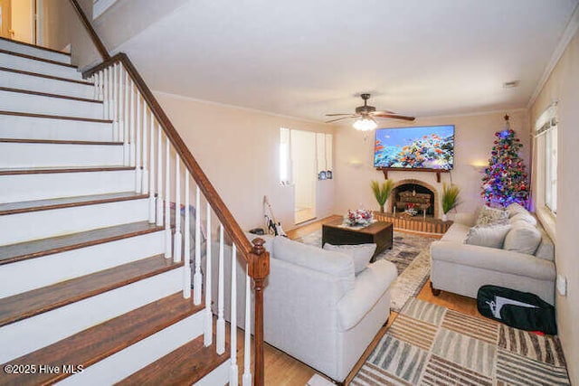 living room featuring ceiling fan, light hardwood / wood-style floors, and ornamental molding