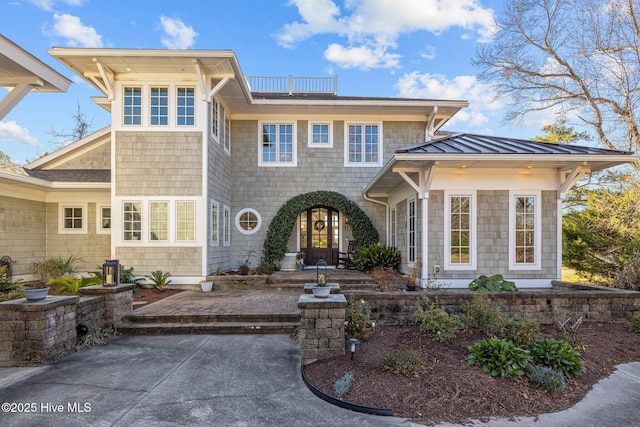 view of front of property featuring a balcony