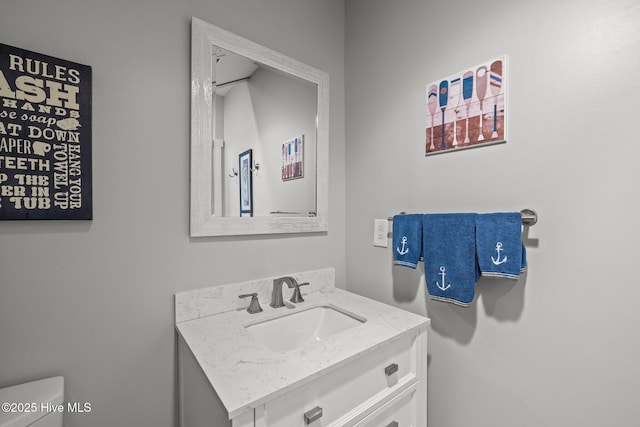 bathroom featuring vanity and toilet