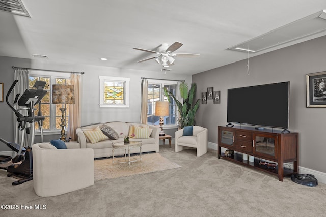 carpeted living room featuring ceiling fan and a healthy amount of sunlight