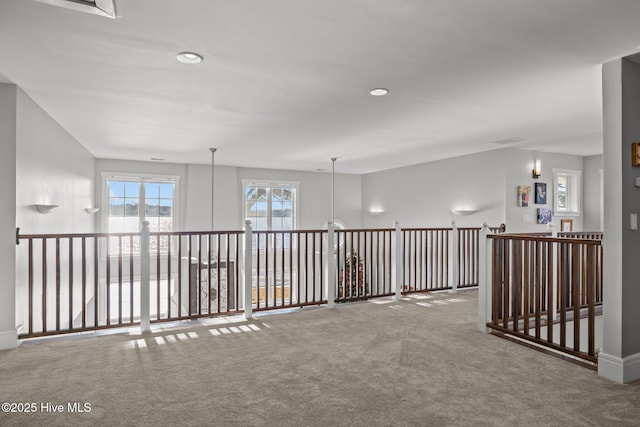 hall with carpet flooring and a chandelier