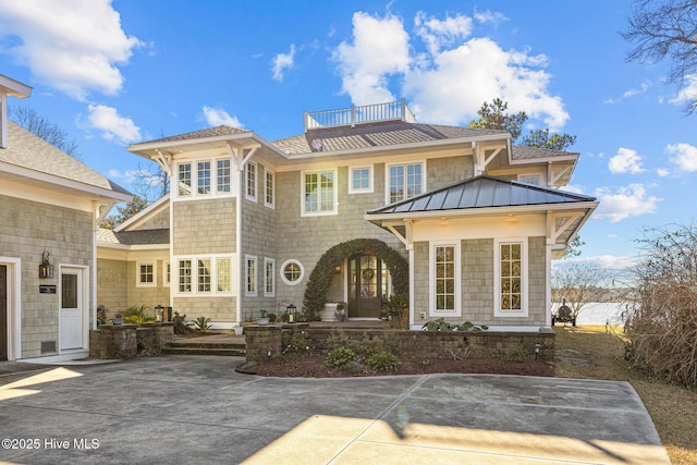 rear view of property with a balcony