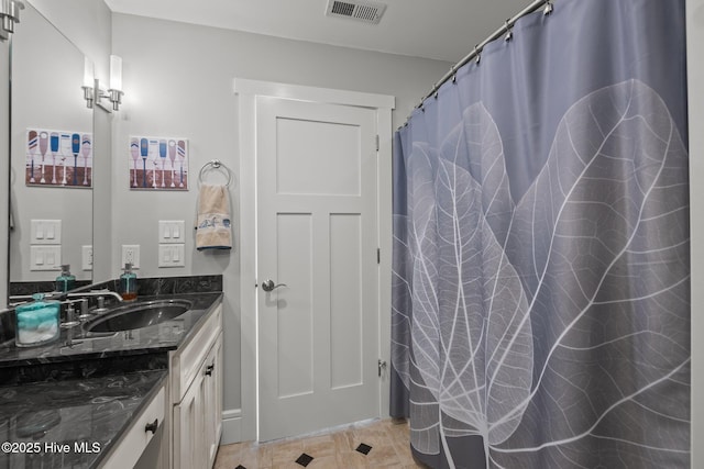 bathroom featuring tile patterned flooring and vanity