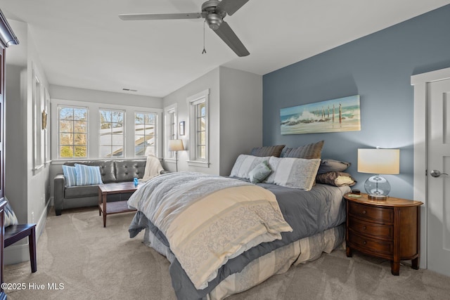 bedroom featuring ceiling fan and light carpet