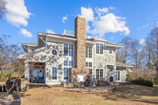 rear view of house featuring a yard and a patio