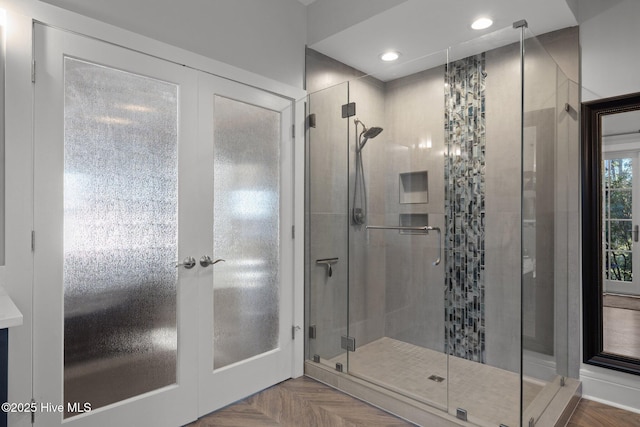 bathroom with an enclosed shower and parquet floors