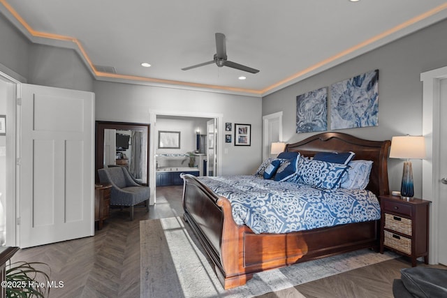 bedroom featuring dark parquet flooring, connected bathroom, ceiling fan, and crown molding