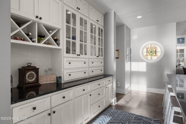 interior space featuring white cabinetry and dark parquet floors