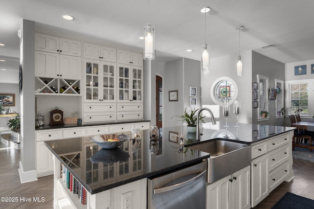 kitchen featuring dishwasher, a spacious island, hanging light fixtures, and dark parquet floors