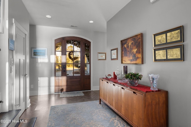 entryway with dark parquet flooring and french doors