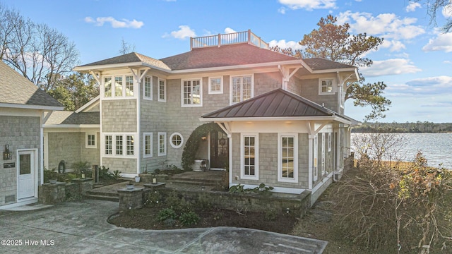 back of house featuring a water view