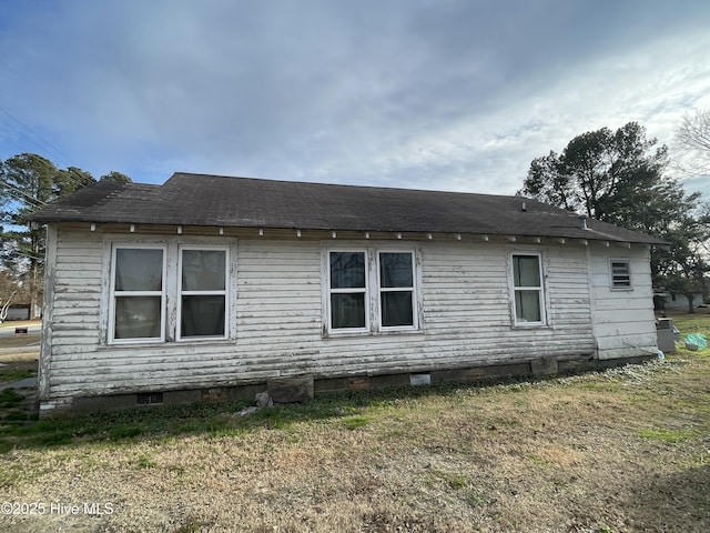 view of property exterior featuring a lawn