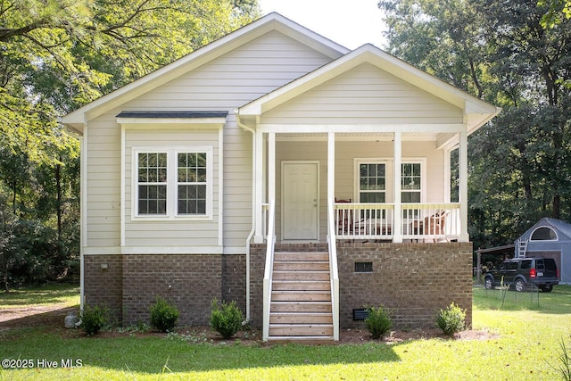 bungalow-style home with a front lawn and a porch