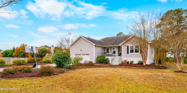 view of side of home featuring a garage, a lawn, and a porch