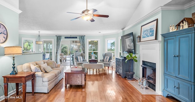 living room featuring ceiling fan, ornamental molding, lofted ceiling, and light hardwood / wood-style floors