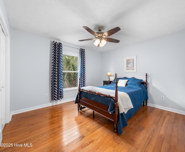 bedroom with ceiling fan, a closet, and hardwood / wood-style flooring