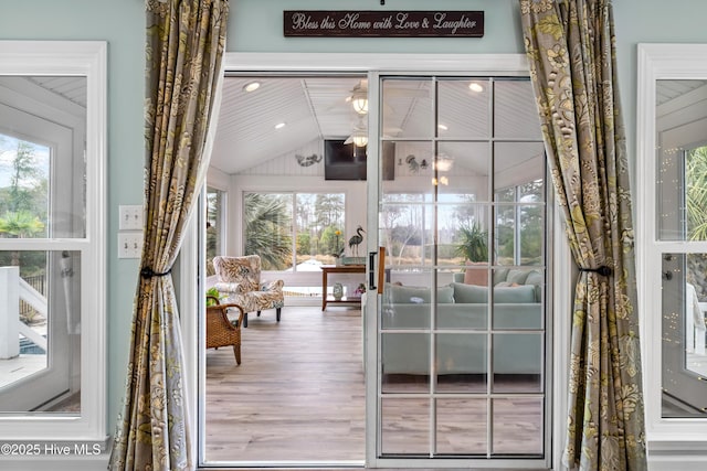 doorway to outside with vaulted ceiling