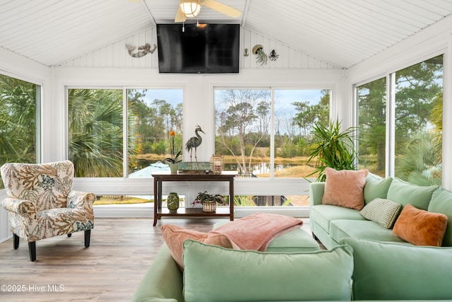 sunroom featuring ceiling fan and vaulted ceiling