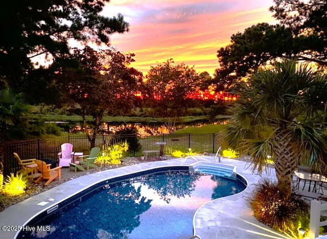 view of pool at dusk