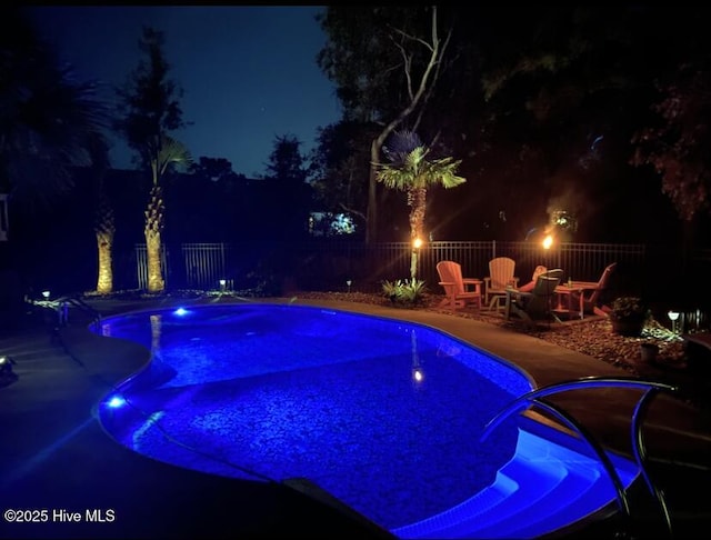 pool at night with a patio