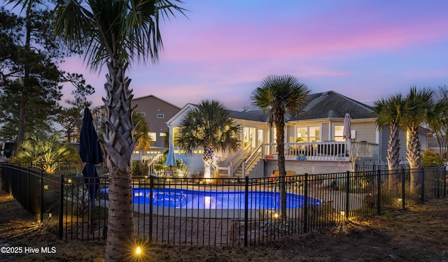 view of pool at dusk