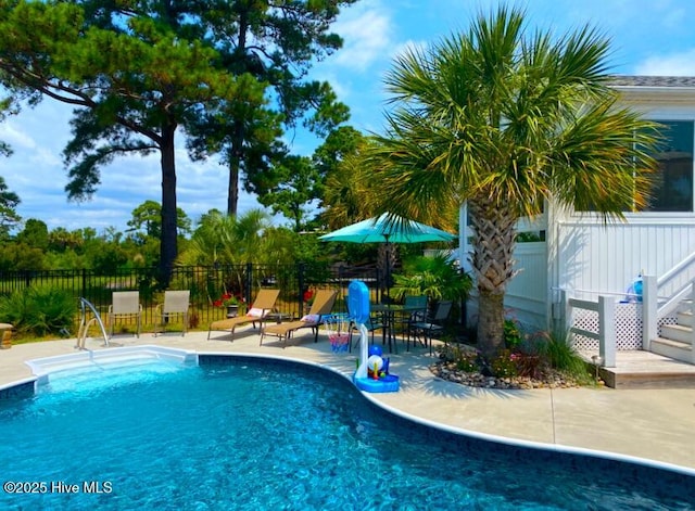 view of swimming pool with a patio area