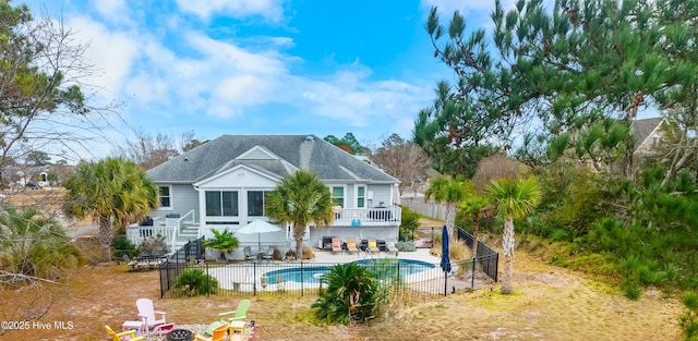 rear view of house with a patio and a fenced in pool