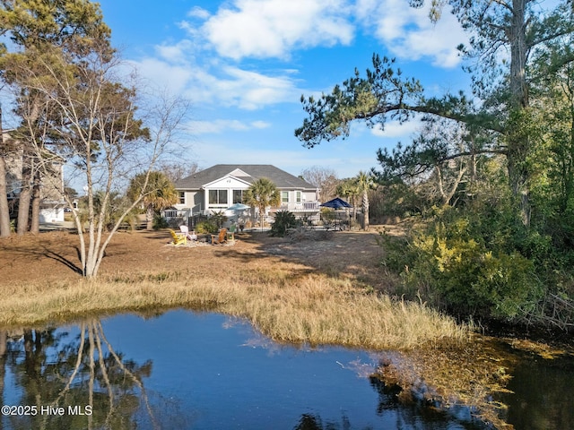 rear view of house featuring a water view