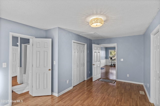 unfurnished bedroom with wood-type flooring and a textured ceiling