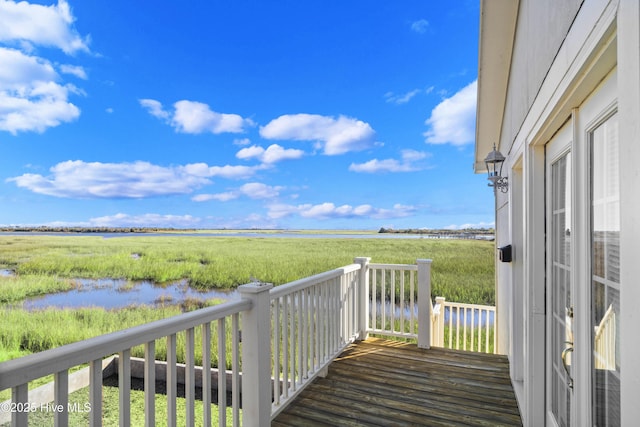 wooden deck with a water view