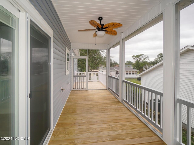 wooden deck featuring ceiling fan