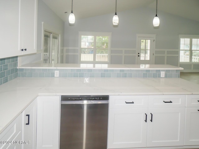 kitchen with white cabinetry, stainless steel dishwasher, lofted ceiling, and decorative light fixtures