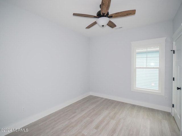 spare room featuring light wood-type flooring and ceiling fan