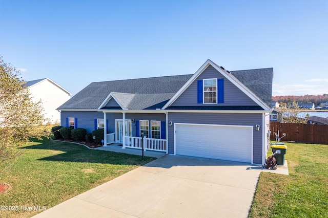 view of front of home with a garage, covered porch, and a front lawn