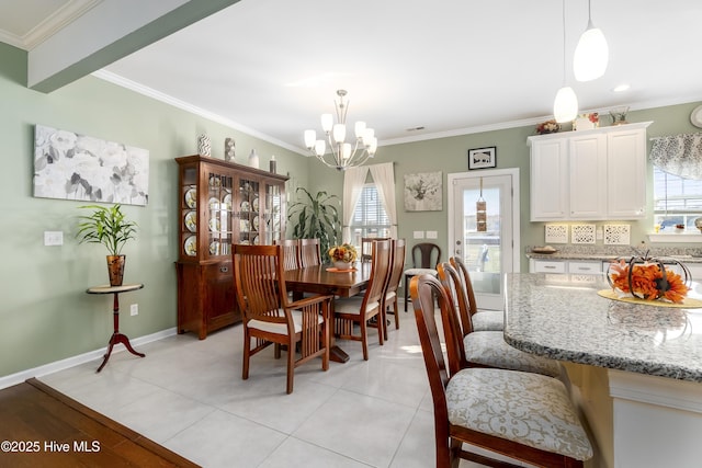 dining room featuring a chandelier, crown molding, and light tile patterned floors