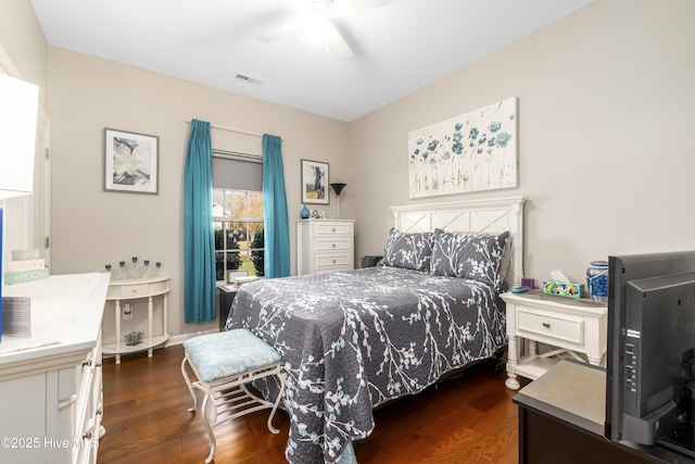 bedroom with ceiling fan and dark hardwood / wood-style floors