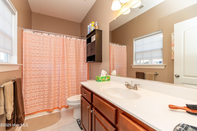 bathroom featuring toilet, tile patterned flooring, walk in shower, and vanity