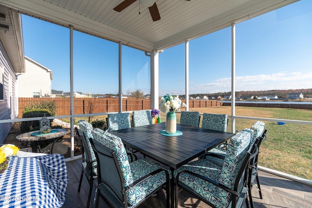 sunroom featuring ceiling fan