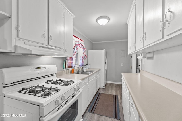 kitchen featuring light hardwood / wood-style floors, white cabinetry, white appliances, and crown molding