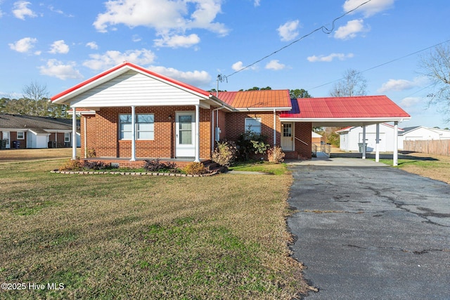 ranch-style home featuring a carport and a front yard